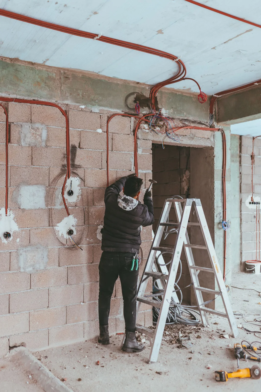 An electrician working inside a residential renovation project